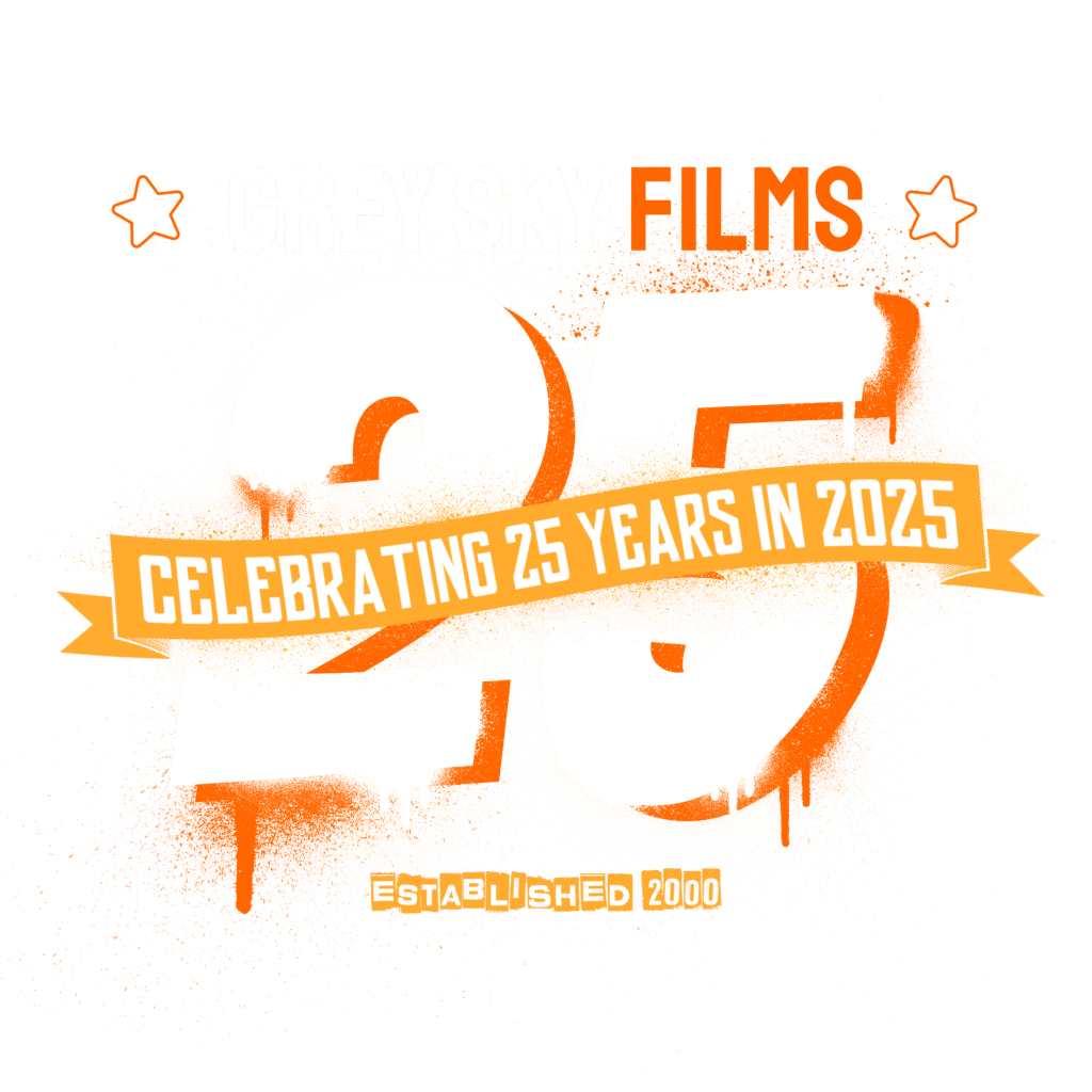 Official 25th anniversary logo for Grey Sky Films, commemorating 25 years of creative video production since the company’s founding in 2000. This bold, celebratory design features spray-painted numerals, star icons, and a banner reading “Celebrating 25 Years in 2025.”